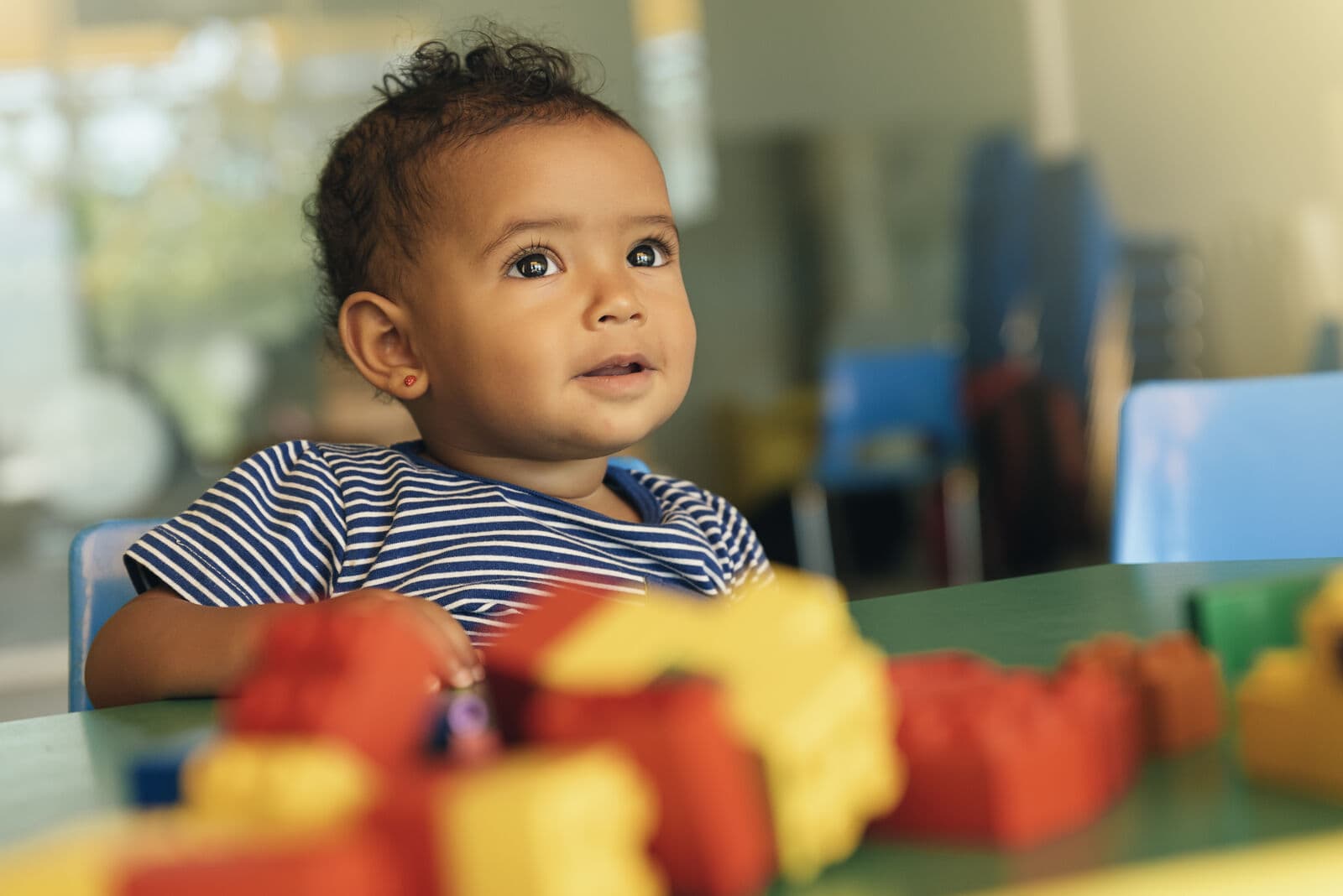 A young child playing with colorful building blocks