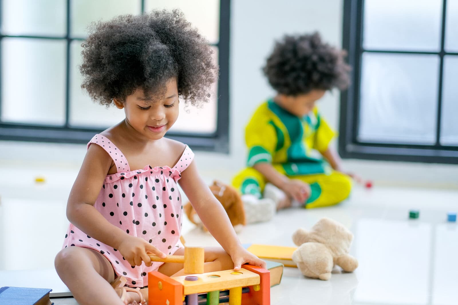 Children playing with toys in a bright room